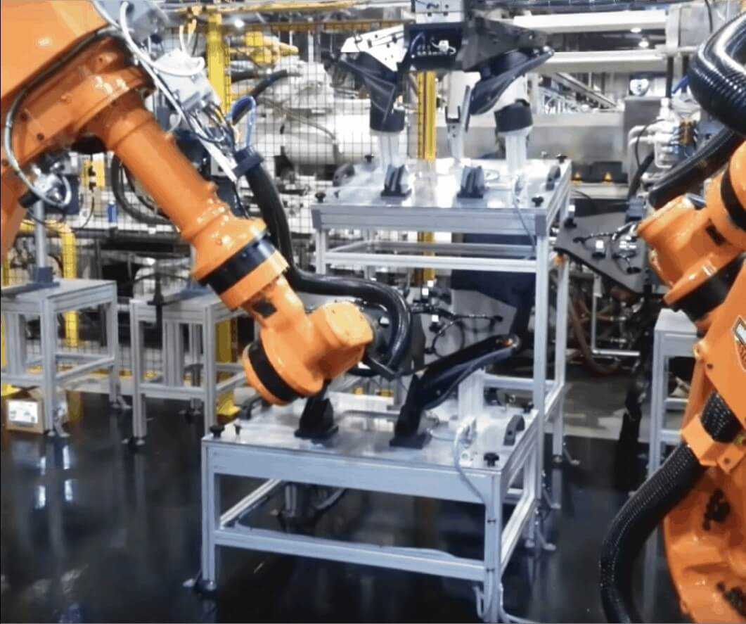 A photo of robot arms in action at Mack Molding.